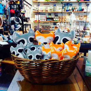 Basket of Petit Loulou handmade plush toys displayed in a local craft boutique in France.