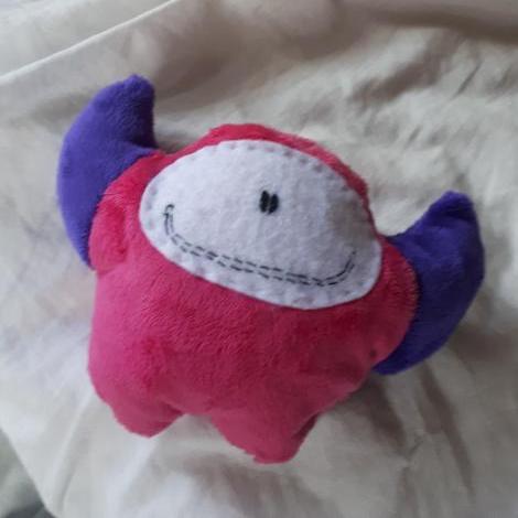 Handmade pink monster with purple horns and a big smile made from Petit Loulou DIY sewing Kit for kids