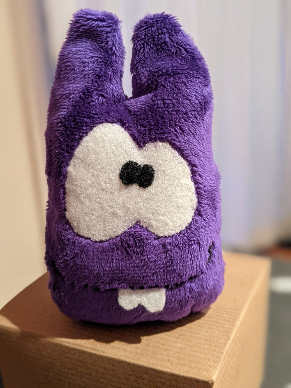 Purple tooth monster plush created using the Petit Loulou DIY sewing kit. A fun and creative project for kids